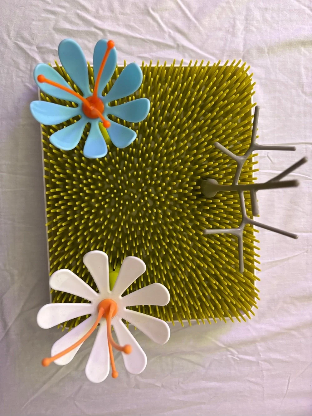 Green Grass-Style Bottle Drying Rack with Blue and White Flower Stems